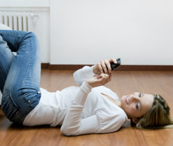 residential hardwood flooring contractor charlotte girl on hardwood floor texting